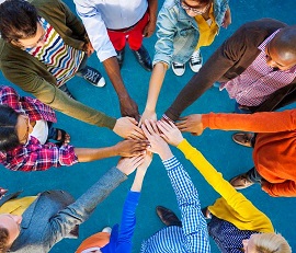 A view from the top of hands in a circle. 